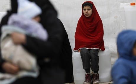 A Syrian girl looks on as aid items to cope with the winter weather are delivered to al-Hol camp in Hasakah governorate in northeastern Syria on January 7, 2019. Photo: Delil Souleiman/AFP