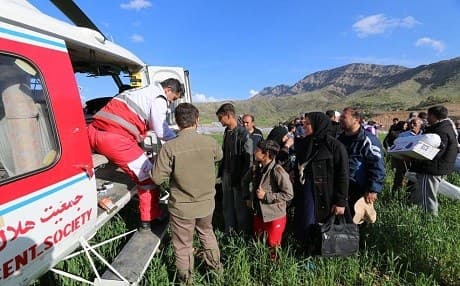People load supplies into an Iranian Federation of Red Cross and Red Crescent aid helicopter. File photo: IFRC
