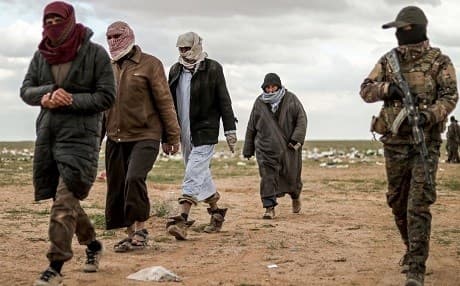 Men suspected of being Islamic State fighters walk next to a member of the Kurdish-led Syrian Democratic Forces (SDF) as they wait to be searched after leaving ISIS' last holdout in Baghouz, Syria on February 27, 2019. File photo: AFP