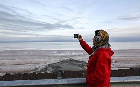 A woman take a photo at Lake Urmia on December 8, 2018. Photo: Atta Kenare/AFP