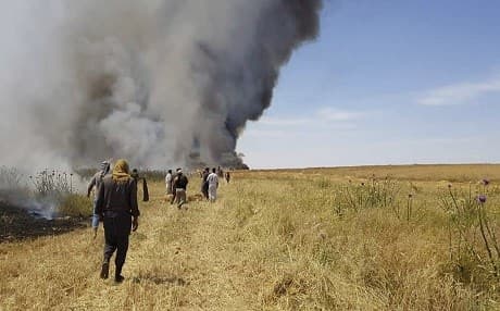 An image provided by the community service group, Together for Jarniyah, which has been authenticated based on its contents and other AP reporting, shows Syrians working to extinguish a fire in a field of crops, in Jaabar, Raqqa province, Syria on May 28, 2019. Photo: Together for Jarniyah via AP