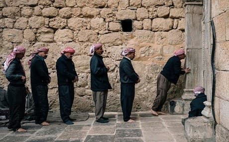 Yezidi men queue outside Lalish temple. File photo: AFP