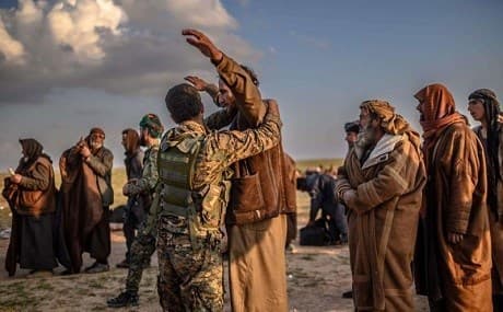 ISIS suspects are searched after leaving the group's last holdout of Baghouz, Syria, February 22, 2019. File photo: AFP
