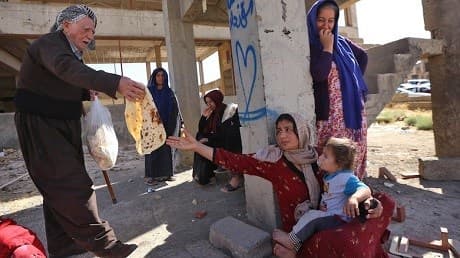 IDPs displaced from Kirkuk, taking shelter in an unfinished building in the Kurdistan Region. Photo: AFP/Safin Hamed