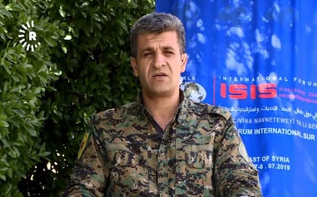 Nuri Mahmoud, the spokesperson for the Peoples' Protection Units (YPG), speaks with Rudaw on the sidelines of the 'International Forum on ISIS: Dimensions, Challenges and Strategies for Confrontations' in Amuda, Syria, on July 6, 2019. Photo: Rudaw video