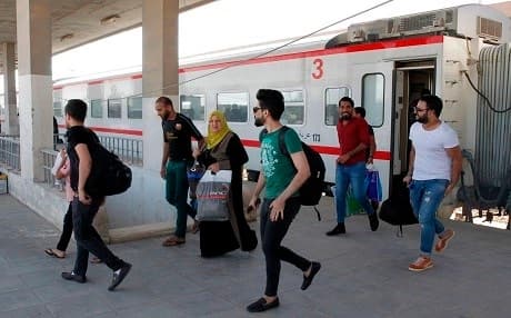 Iraqi passengers disembark from a train from Baghdad in the city of Fallujah on August 19, 2019. Photo: AFP