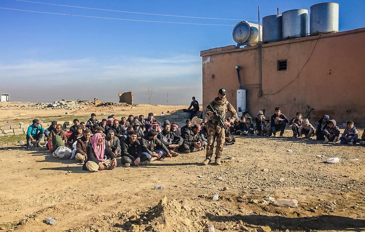 A PMF fighter detains a group of residents at a checkpoint in northern Qayyarah, Mosul, nothern Iraq, October 25, 2016. File photo: Fazel Hawramy / Rudaw