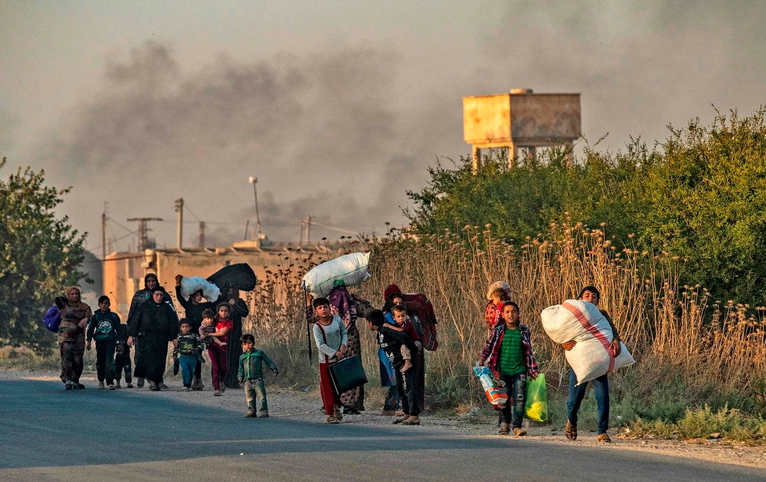 Civilians flee the northeastern Syrian town of Ras al-Ain, Hasaka province on October 9, 2019. Photo: AFP / Delil Souleiman