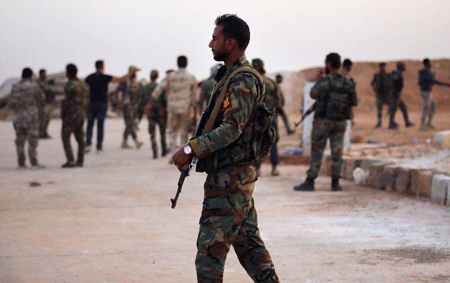 A handout picture released by the official Syrian Arab News Agency (SANA) on October 14, 2019 shows Syrian government forces gathering at Tabqa air base in Syria's Raqqa region. Photo: AFP / SANA