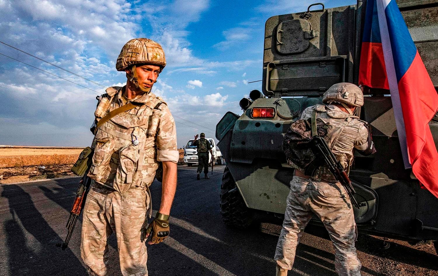Russian military police stand outside an armored vehicle along a road in the countryside near the northeastern Syrian town of Amuda, Hasaka province, October 24, 2019. Photo: Delil Souleiman / AFP