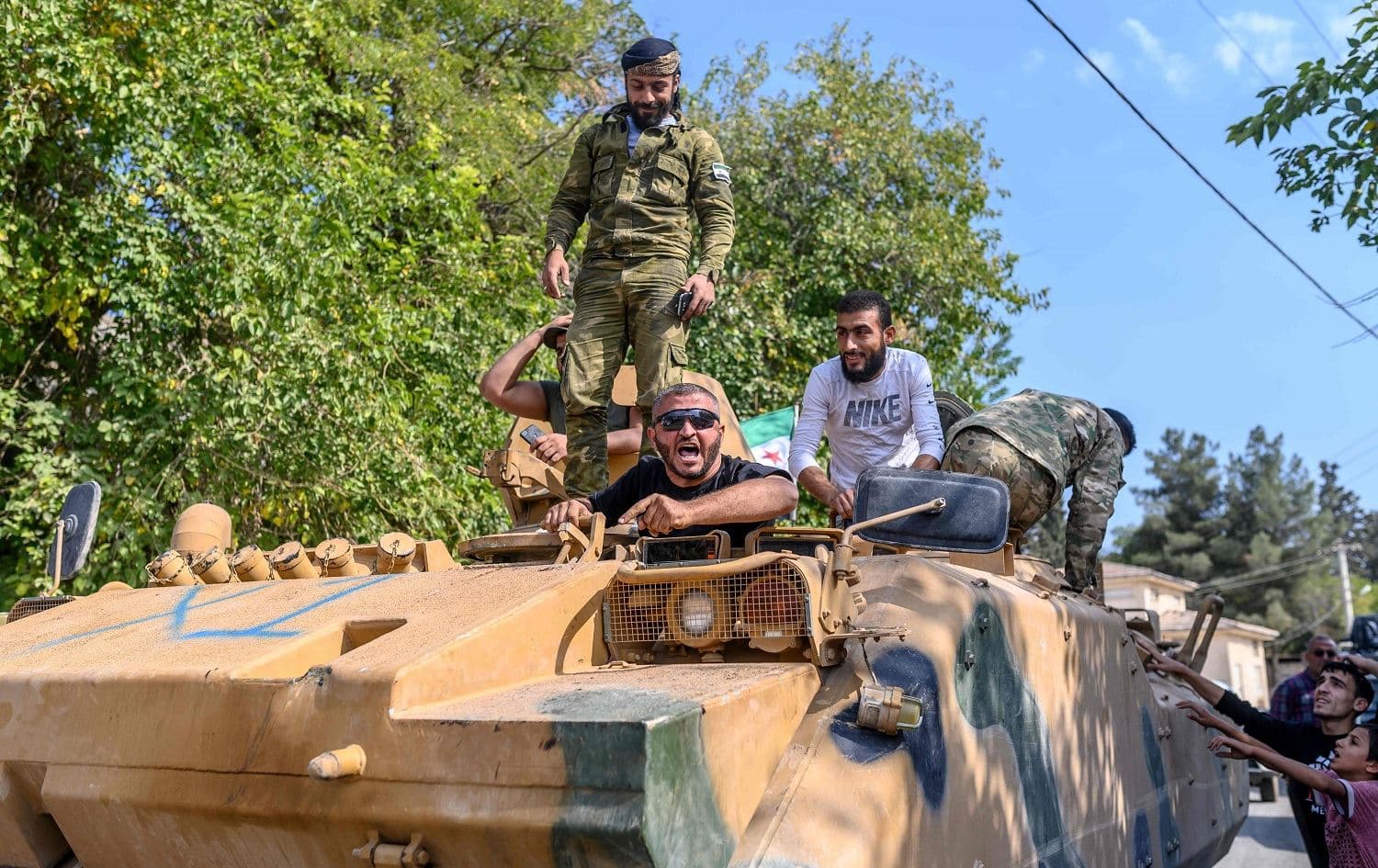 Turkey-backed Syrian National Army (SNA) fighters drive in Sanliurfa, on October 18, 2019. Photo: AFP / Bulent Kilic