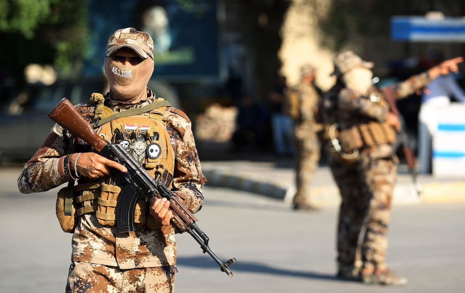 Members of the Hashed al-Shaabi, or Popular Mobilisation Forces (PMF), paramilitaries stand guard during a funerary procession for Wissam Alyawi, a leading commander of the Asaib Ahl Al-Haq faction that is part of the PMF, in the Iraqi capital Baghdad on October 26, 2019. Photo:Ahmad Al-Rubaye/AFP