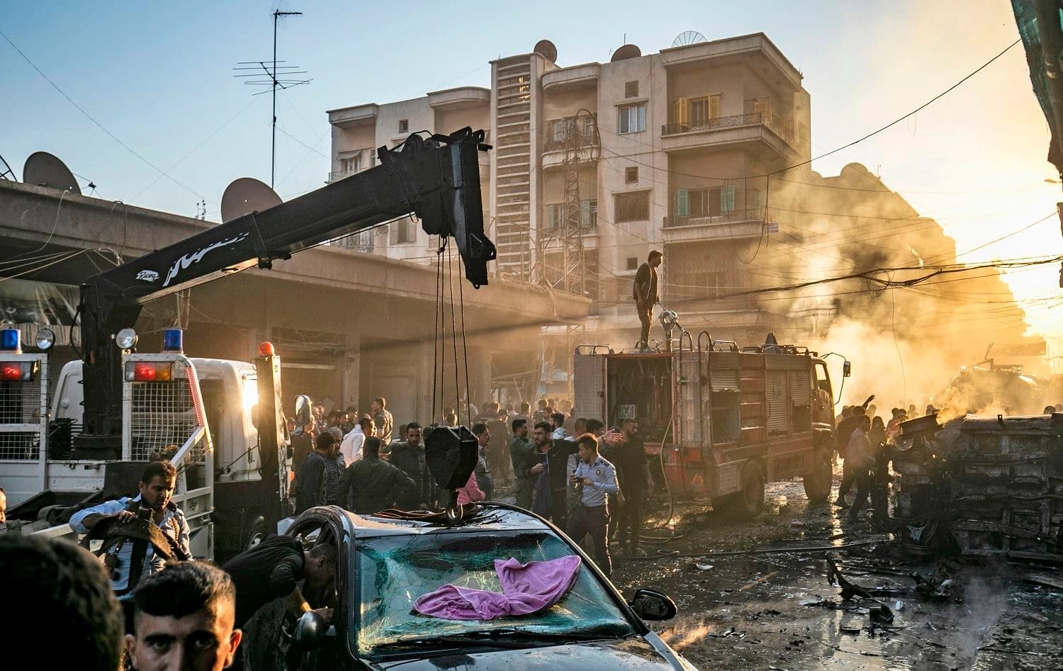 Firefighters and security work at the site of an explosion in the northeastern Syria city of Qamishli on November 11, 2019. Photo: AFP / Delil Souleiman