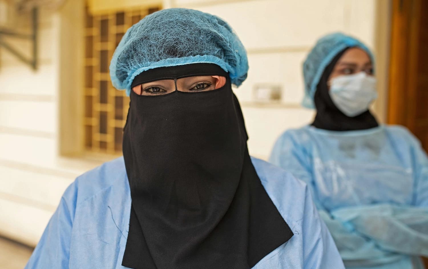 A nurse wears a facemask with a full face veil at Basra University Hospital, April 1, 2020. Photo: Hussein Faleh / AFP