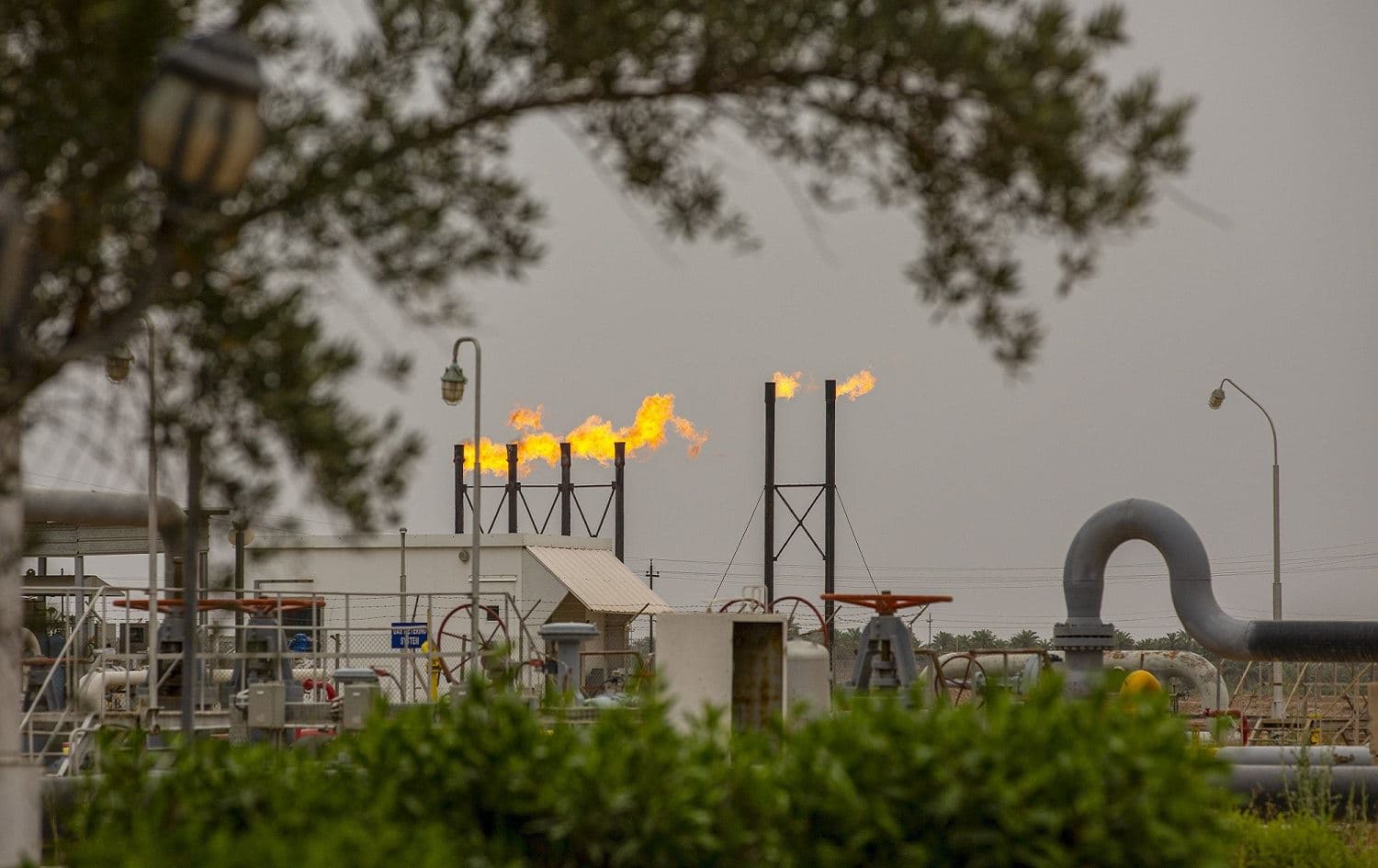 Flames rise from the burning of excess hydrocarbons at the Nahr Bin Omar natural gas field, north of the southern Iraqi port of Basra, April 21, 2020. Hussein Faleh / AFP