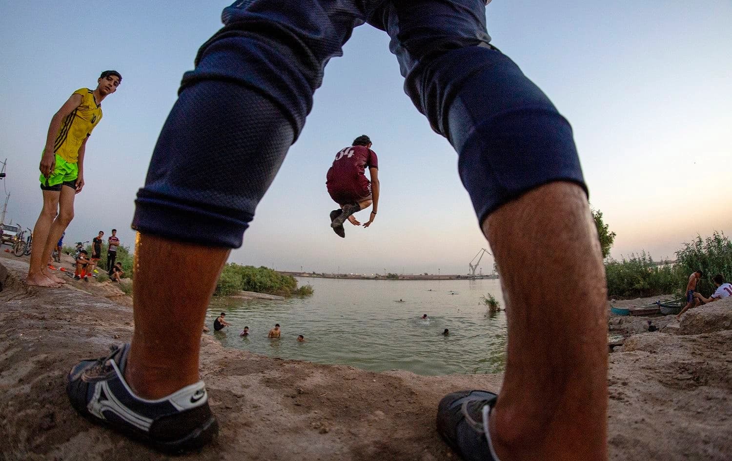 An Iraqi youth dives into the Shatt Al-Arab river in the southern port city of Basra on June 9, 2020. Photo: Hussein Faleh/ AFP