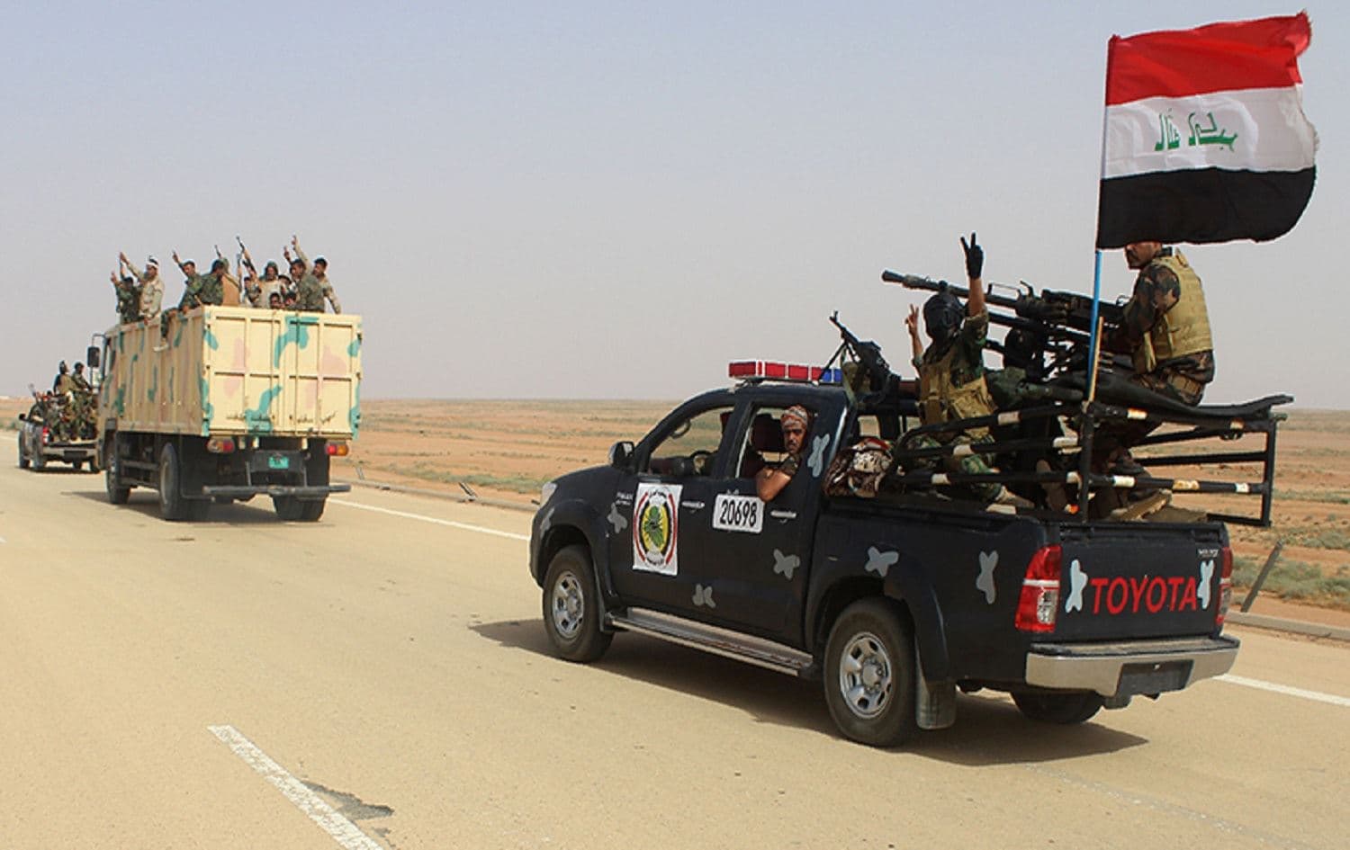 Iraqi government forces and local tribal fighters drive on the highway between the city of Ramadi and the town of Rutba, Iraq on May 16, 2016. Photo: Moadh al-Dulaimi/AFP