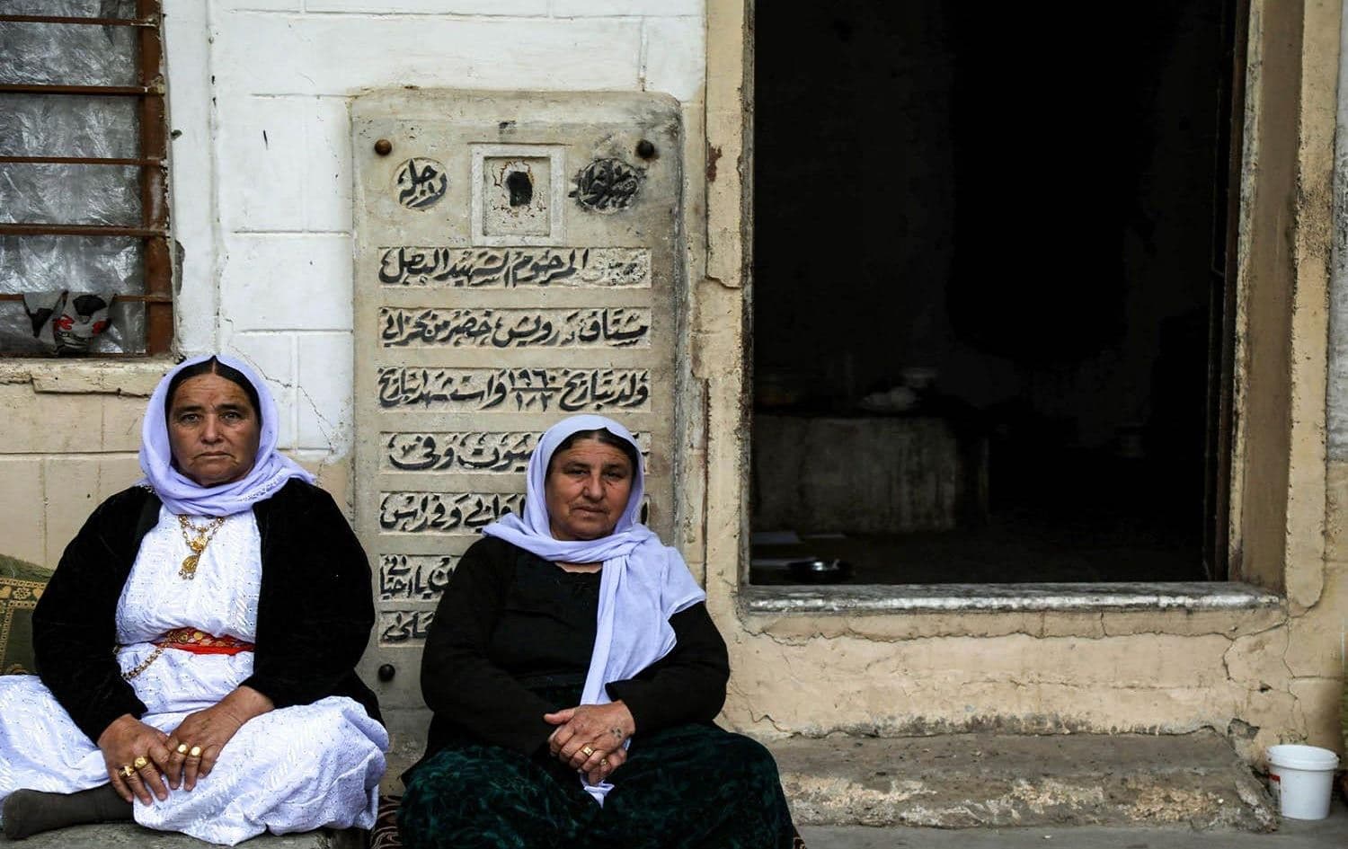 Yezidi women sit outside the Temple of Lalish on April 16, 2019, during a ceremony marking the Yezidi New Year. File photo: AFP