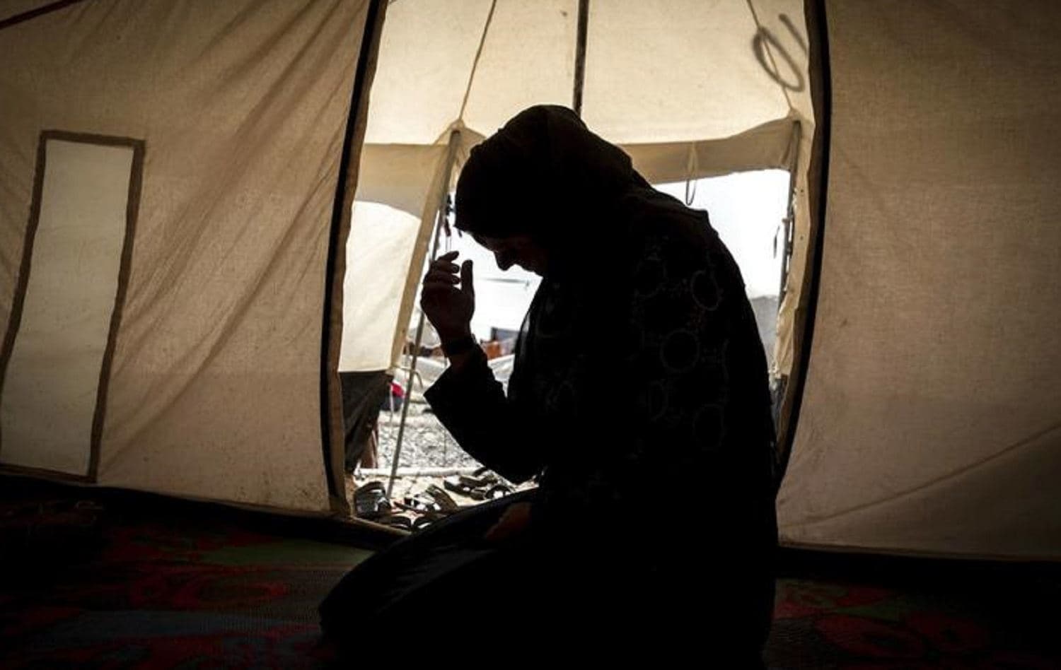 A mother inside her tent in Salamiya camp. Photo: Claire Thomas / Amnesty International via AP