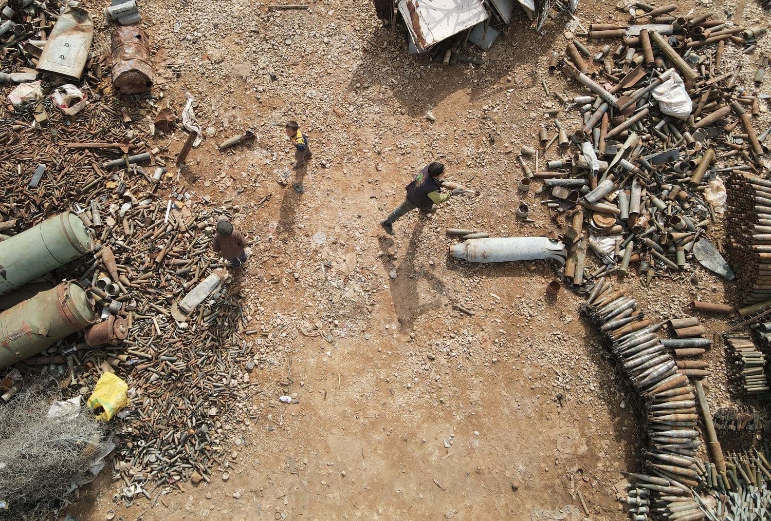 Syrian children sort scraps at a metal scrapyard on the outskirts of Maaret Misrin town in the northwestern Idlib province, on March 10, 2021. Photo: Aaref Watad / AFP
