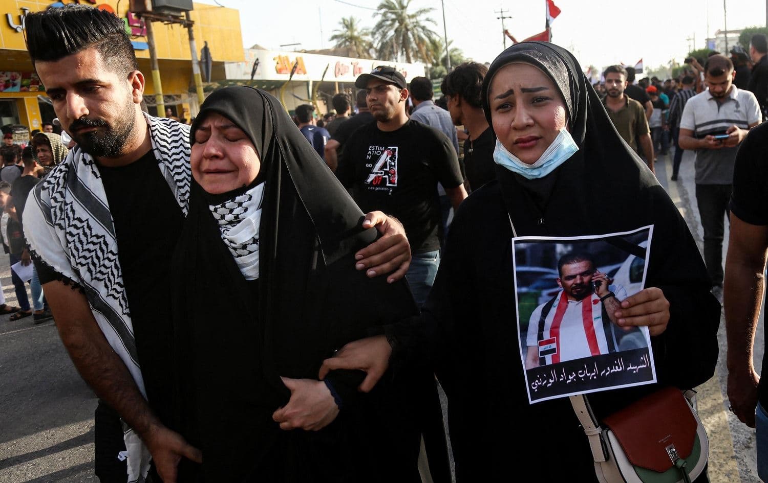 Mourners react as they march during a funerary procession for Iraqi anti-government activist Ihab al-Wazni in Karbala, Iraq on May 9, 2021. Photo: Mohammed Sawaf/AFP