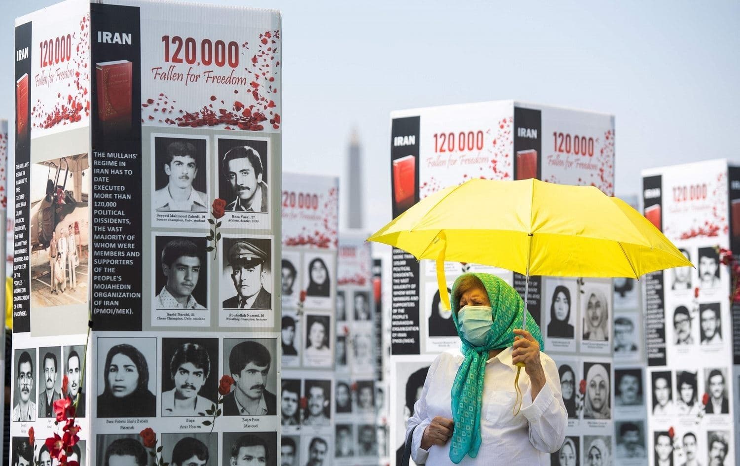 A woman walks past some of the thousands of photos of people killed in Iran during the 1988 massacre, in a photo exhibit in Washington DC in September 2020. File photo: Saul Loeb/AFP