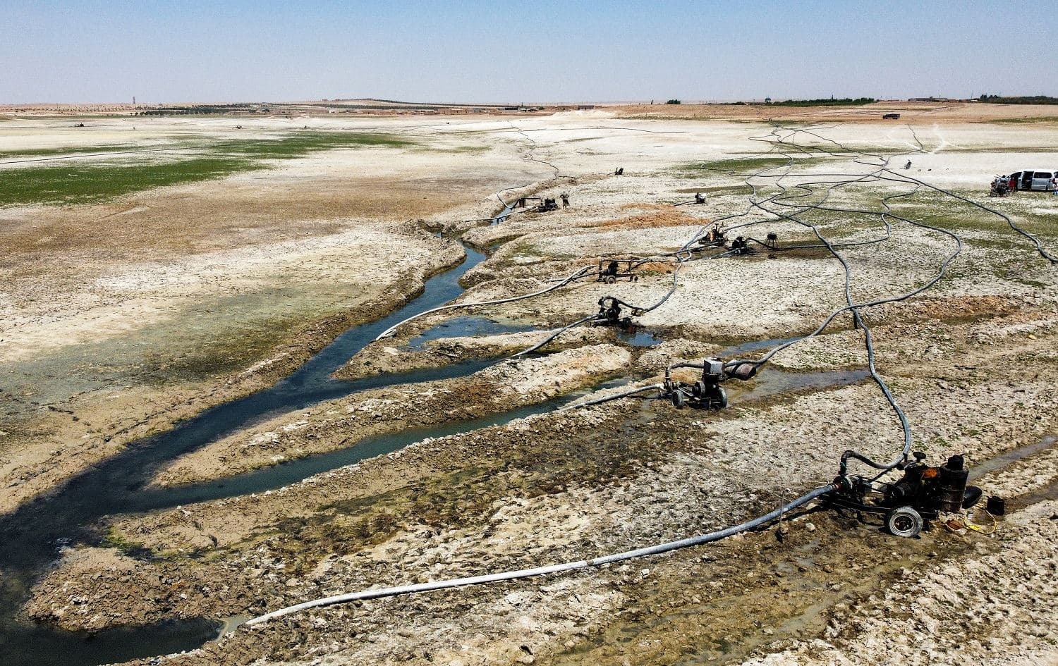 This picture taken on July 27, 2021 shows an aerial view of water pumps drawing water from the Lake Assad reservoir along the Euphrates river in eastern Syria. Photo: Delil Souleiman/AFP