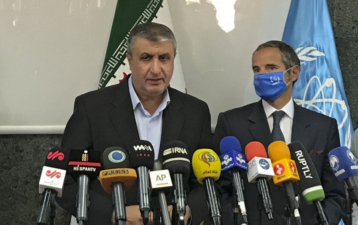 Head of the Atomic Energy Organization of Iran (AEOI) Mohammad Eslami speaks to the media next to Director General of the International Atomic Energy Agency (IAEA) Rafael Grossi following their meeting in Tehran on September 12, 2021. Photo: handout/AEOI/AFP