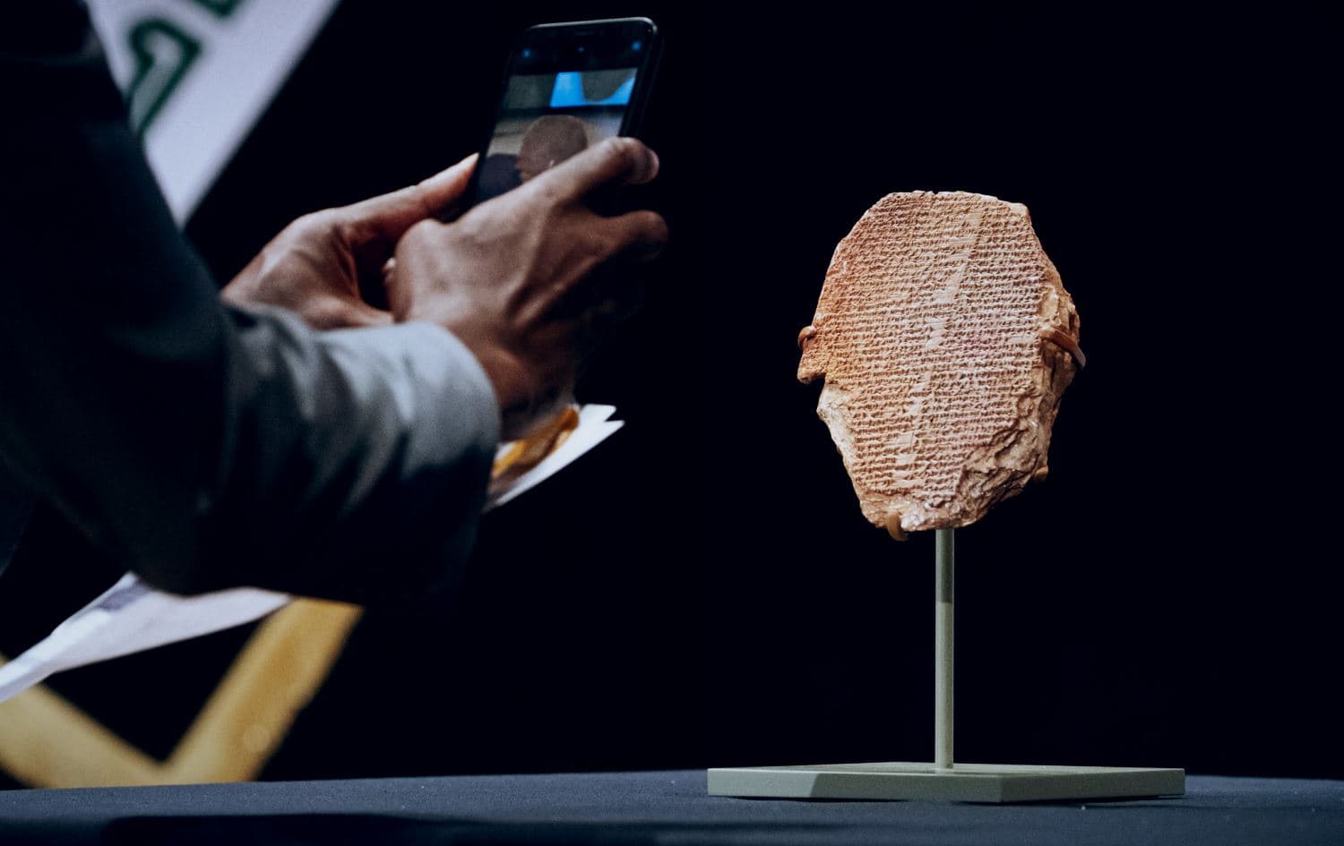 A man photographs the Gilgamesh Tablet, a 3,500-year-old Mesopotamian cuneiform clay tablet that was believed to be looted from Iraq around 1991 and illegally imported into the US. Photo: AFP