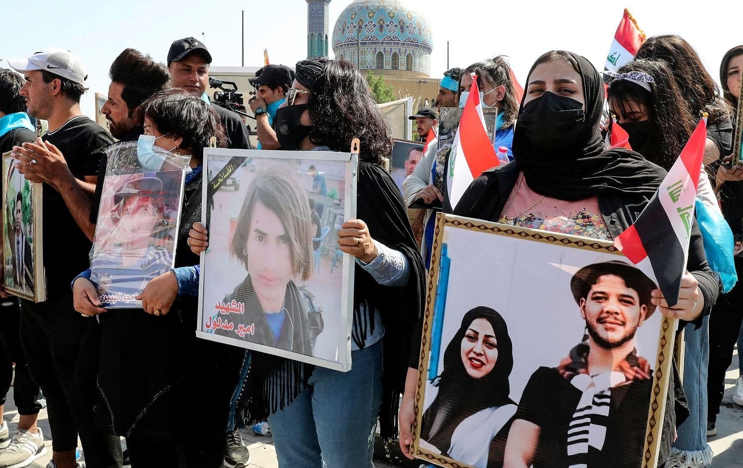 Iraqis hold pictures of demonstrators killed during the Tishreen protests as they rally in Baghdad on October 1, 2021. Photo: Sabah Arar/AFP