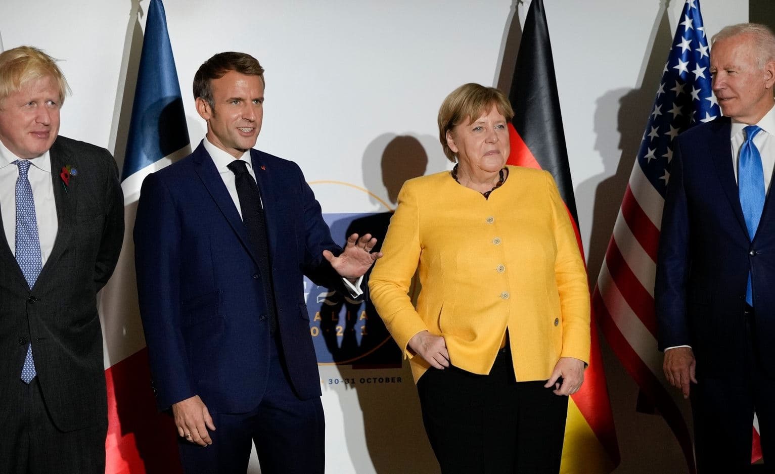 British Prime Minister Boris Johnson, French President Emmanuel Macron, German Chancellor Angela Merkel, and U.S. President Joe Biden, from left, pose for the media prior to a meeting on Saturday for the G20 summit in Rome. Photo: AP/Kirsty Wigglesworth