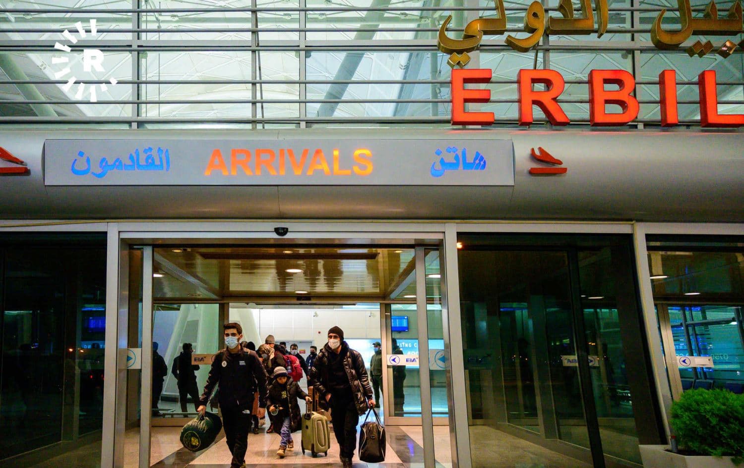 Kurds returning from Belarus on a government repatriation flight exit Erbil International Airport early in the morning on November 26, 2021. Photo: Bilind T. Abdullah/Rudaw