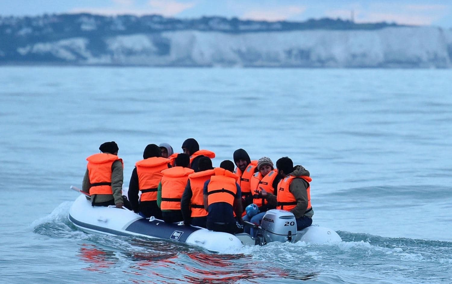 A group of migrants in a dinghy approach southern England after crossing the Channel from France on September 1, 2021. Photo: Glyn Kirk / AFP
