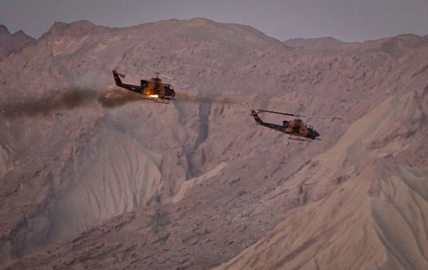 This handout photo provided by Iran's IRGC on December 23, 2021, shows a tank firing missiles as part of five-days military exercises dubbed Payambar-e-Azadm, held in three provinces