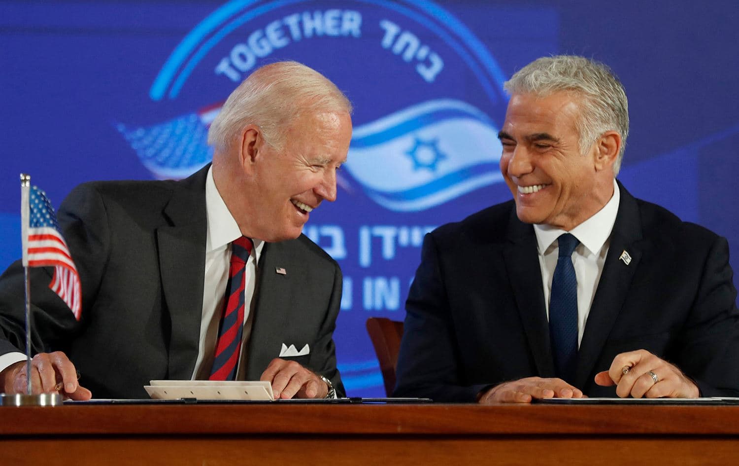 US President Joe Biden and Israel's Prime Minister Yair Lapid, smile after signing a security pledge in Jerusalem, on July 14, 2022. Photo: Atef Safadi/AFP