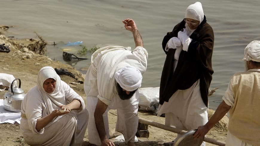 A Sabean-Mandaean woman prepares food to mark Eid al-Khalqeh on the banks of the Tigris River in Baghdad. File photo: AFP