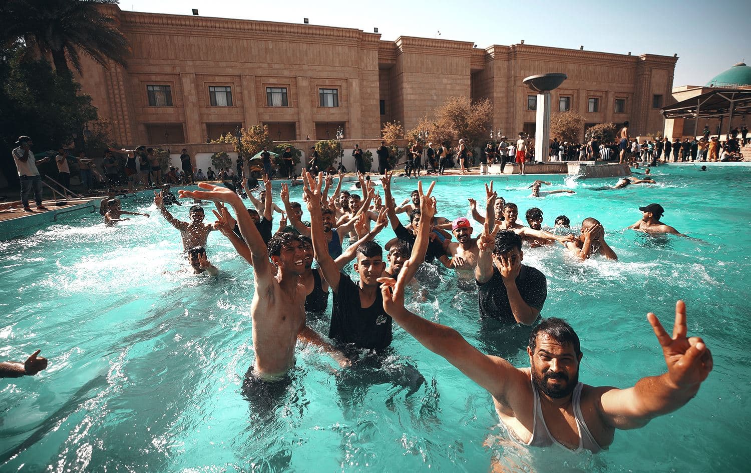 Supporters of Iraqi Shiite cleric Moqtada Sadr swim in the pool of the Government Headquarters in the capital Baghdad's Green Zone, on August 29, 2022. Photo: Ahmed al-Rubaye/AFP