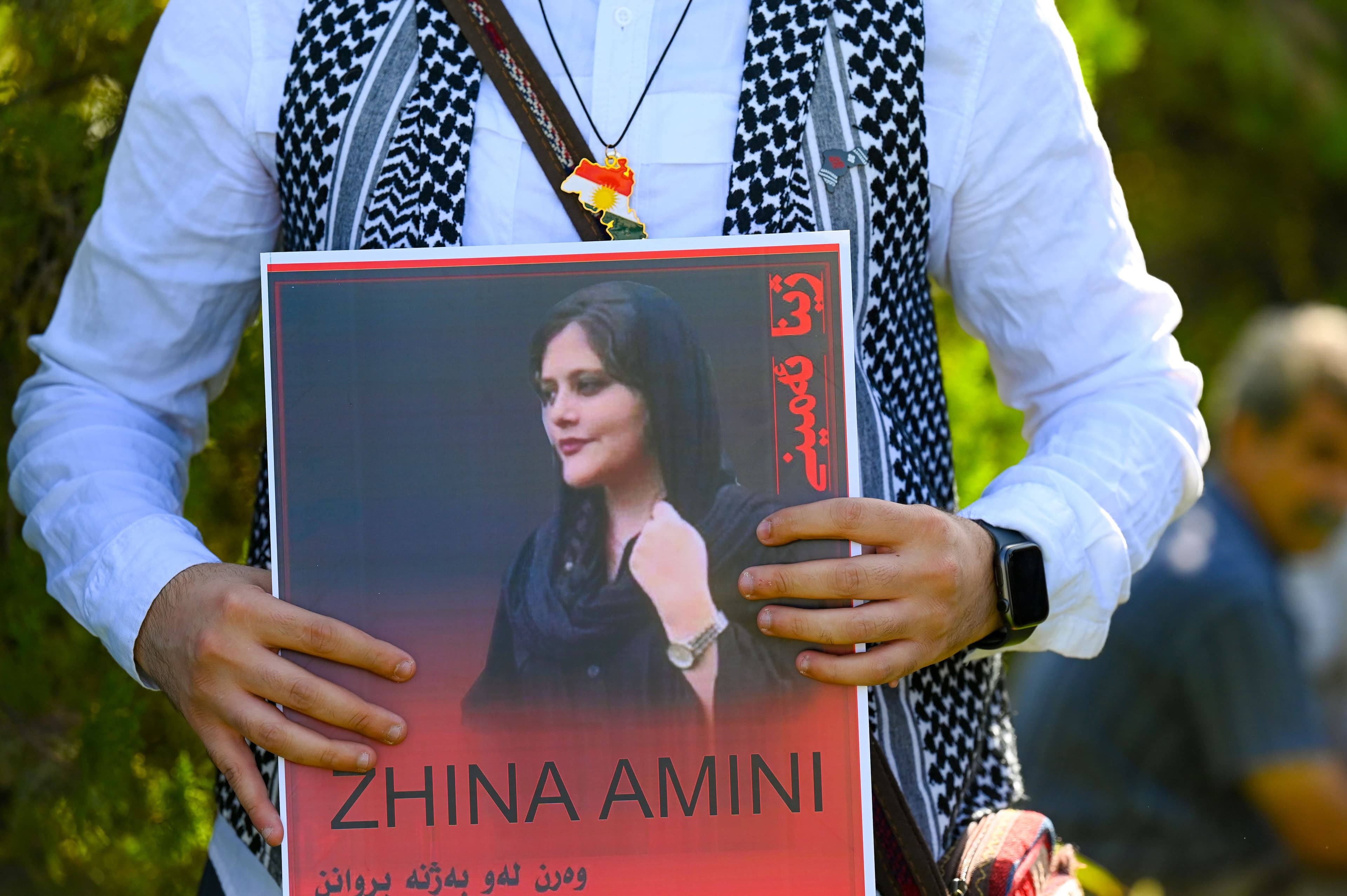 A protester holds a poster in Erbil which shows the portrait of Mahsa (Zhina) Amin. Date: September 24, 2022. Photo: Bilind T. Abdullah/Rudaw