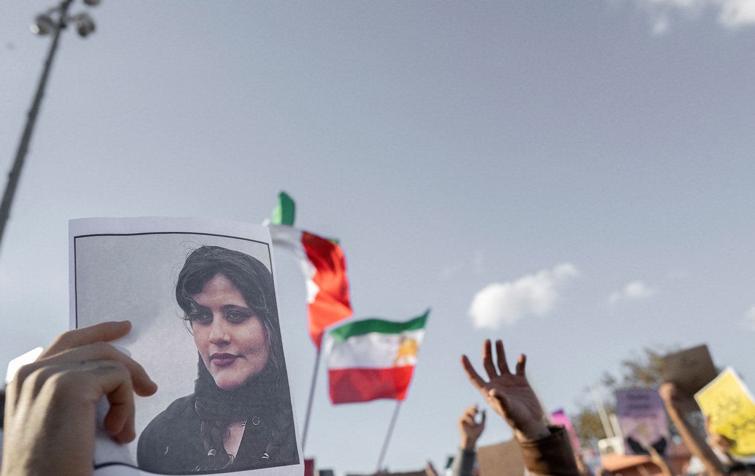 A protestor holds a photo of Kurdish Iranian woman Mahsa Amini during a demonstration against the Iranian regime and in support of Iranian women, after Amini died after being arrested in Tehran by the Islamic Republic's morality police, in Istanbul on October 2, 2022. Photo: Bulent Kilic/AFP