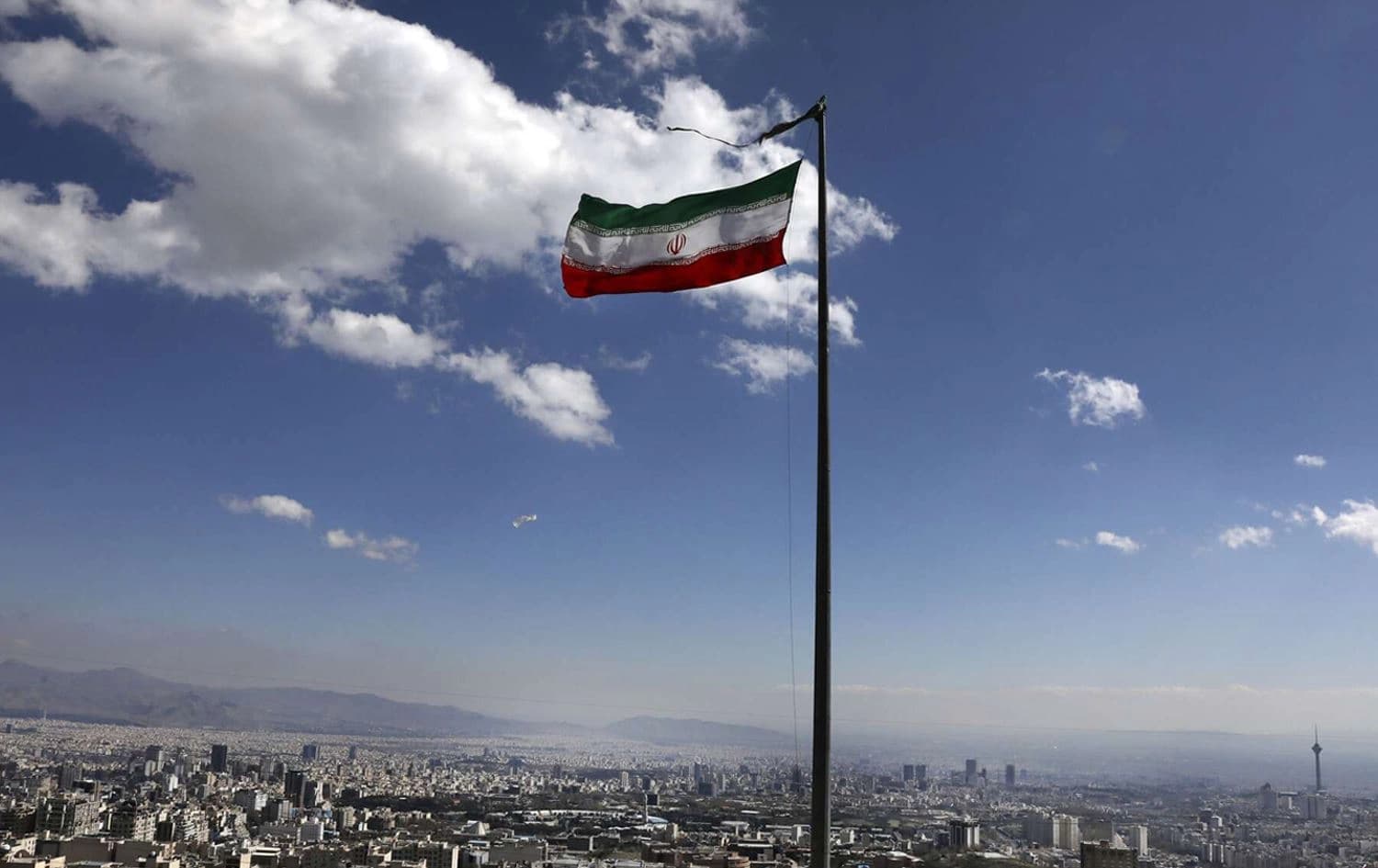 Iran's national flag waves in northern Tehran, Iran on March 31, 2020. Photo: Vahid Salemi/AP