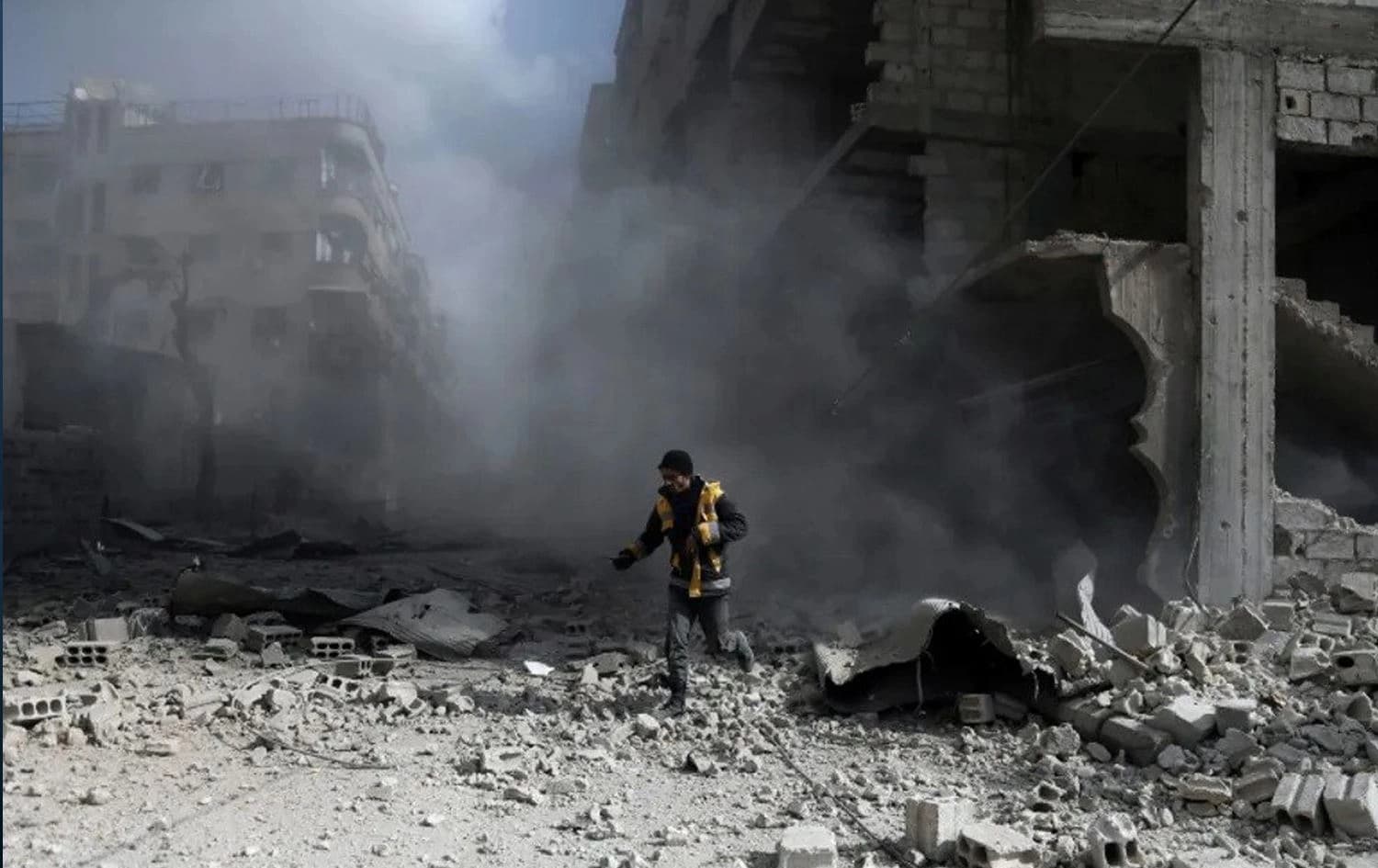 A civil defence volunteer checks the site of a regime air strike in the rebel-held town of Saqba, in the besieged Eastern Ghouta region on the outskirts of the capital Damascus, on February 23, 2018. Photo: Abdulmonam Eassa/AFP