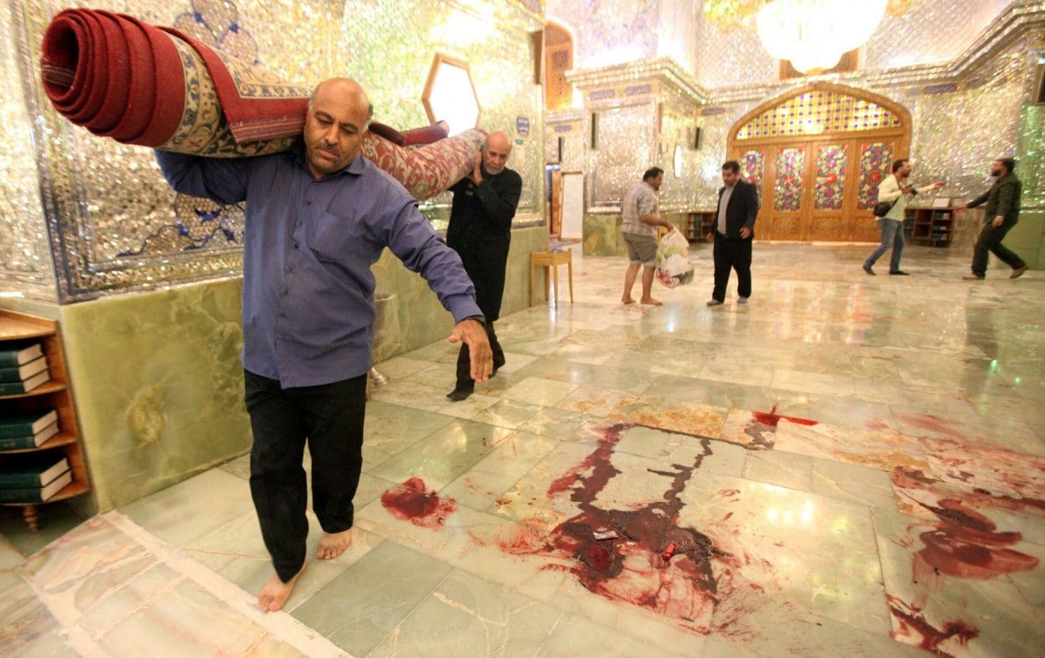 Workers clean after a deadly armed attack at the Shah Cheragh mausoleum in Shiraz, Iran on October 26, 2022. File photo: ISNA/AFP