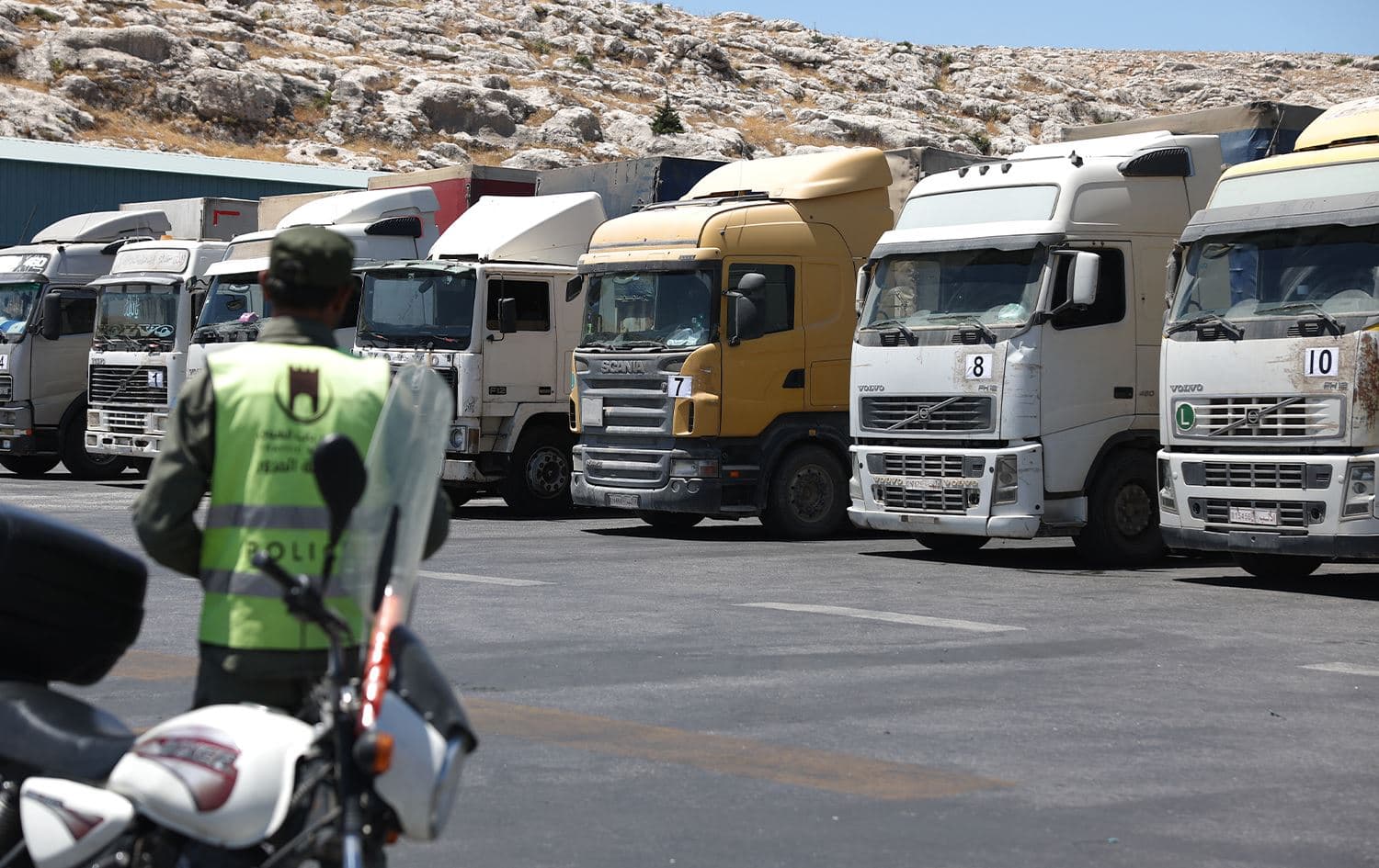 A convoy of trucks carrying humanitarian aid is seen parked after crossing the Syrian Bab al-Hawa border crossing with Turkey, on July 10, 2023. Photo: Omar Haj Kadour/AFP