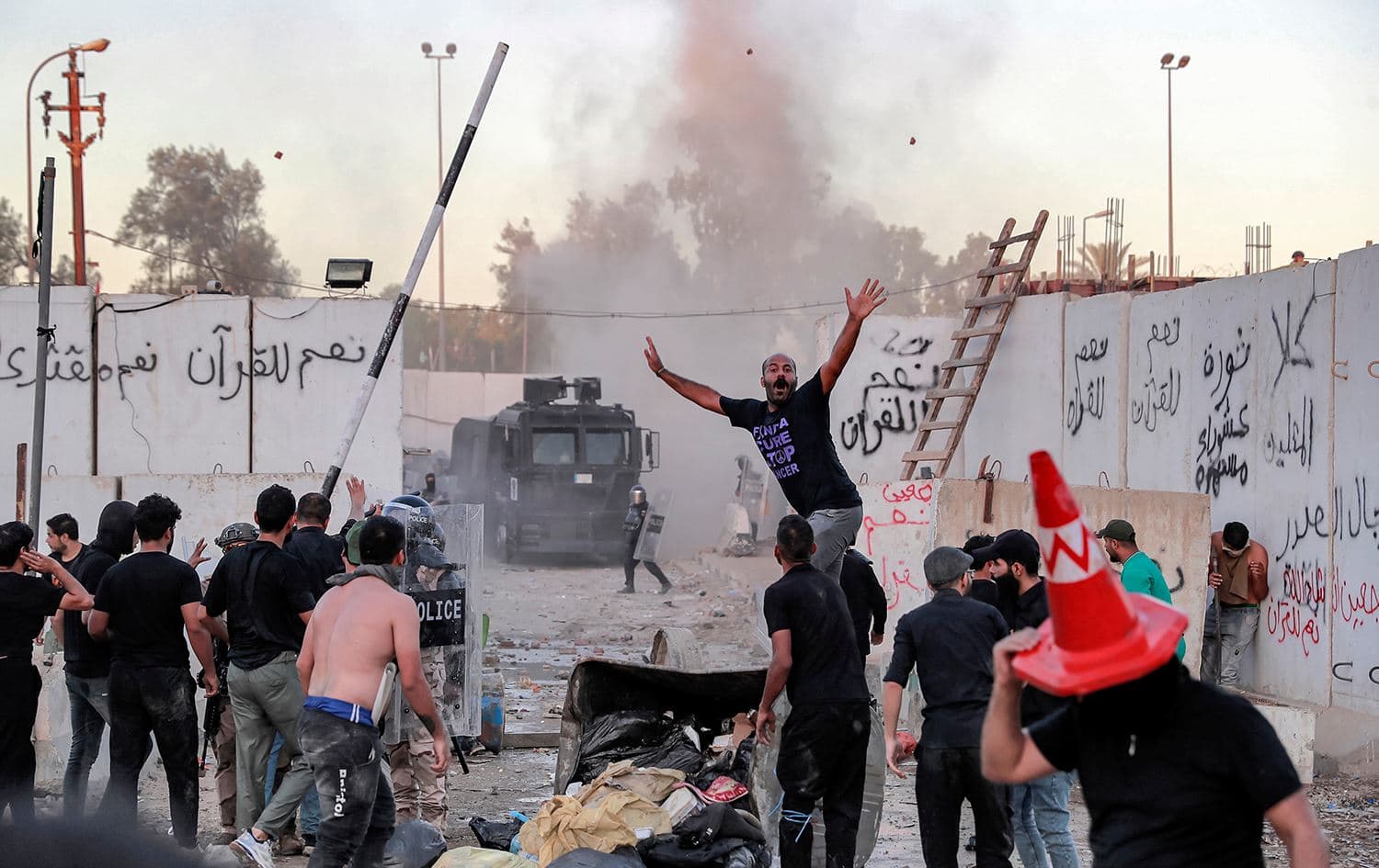 Iraqi riot police try to disperse supporters of Iraqi Shiite cleric Muqtada al-Sadr gathering for a protest outside the Swedish embassy in Baghdad on July 20, 2023. Photo: Ahmad Al-Rubaye/AFP