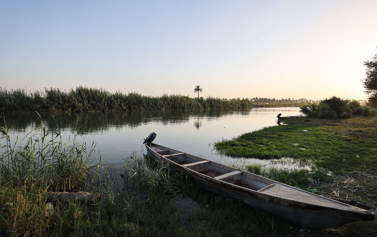 A fishing boat is moored on the banks of a branch of the Euphrates River in the town of Al-Hamza near the city of Hilla on July 6, 2023. Photo: Ahmed al-Rubaye/AFP