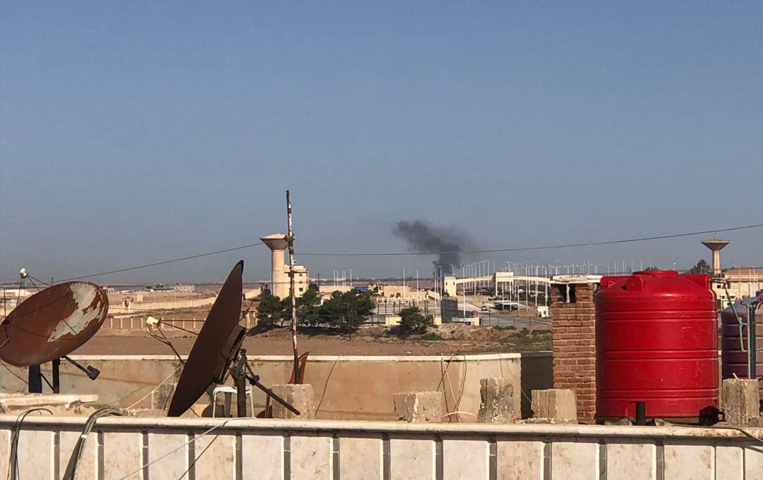 Smoke billows in the distance after a suspected Turkish drone strike targeted the Hasaka-Tel Tamr road on October 5, 2023. Photo: ANHA