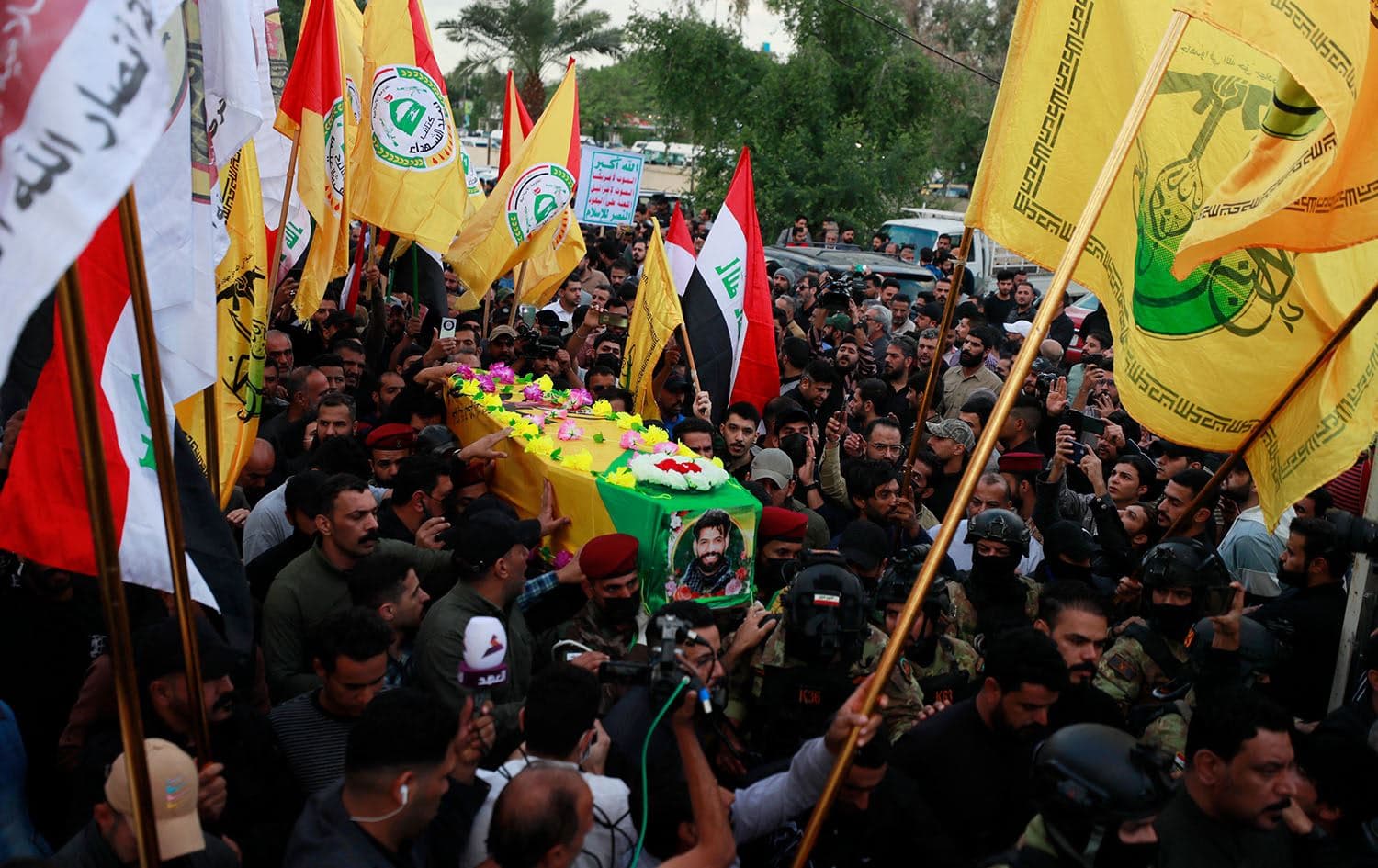 Iraqi mourners carry the coffin of Fadel al-Maksusi, a Kataeb Hezbollah fighter who was also part of the “Islamic resistance in Iraq”, the group that has claimed all recent attacks against US troops in Iraq and Syria, during a funeral in Baghdad on November 21, 2023. Photo: Ahmad al-Rubaye/AFP