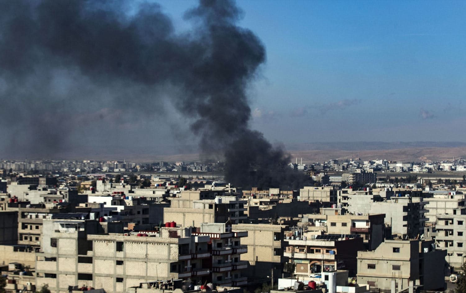 Smokes billows in Qamishli in northeastern Syria close to the Turkish border amid Turkish military strikes in the area on December 25, 2023. Photo: Delil Souleiman/AFP