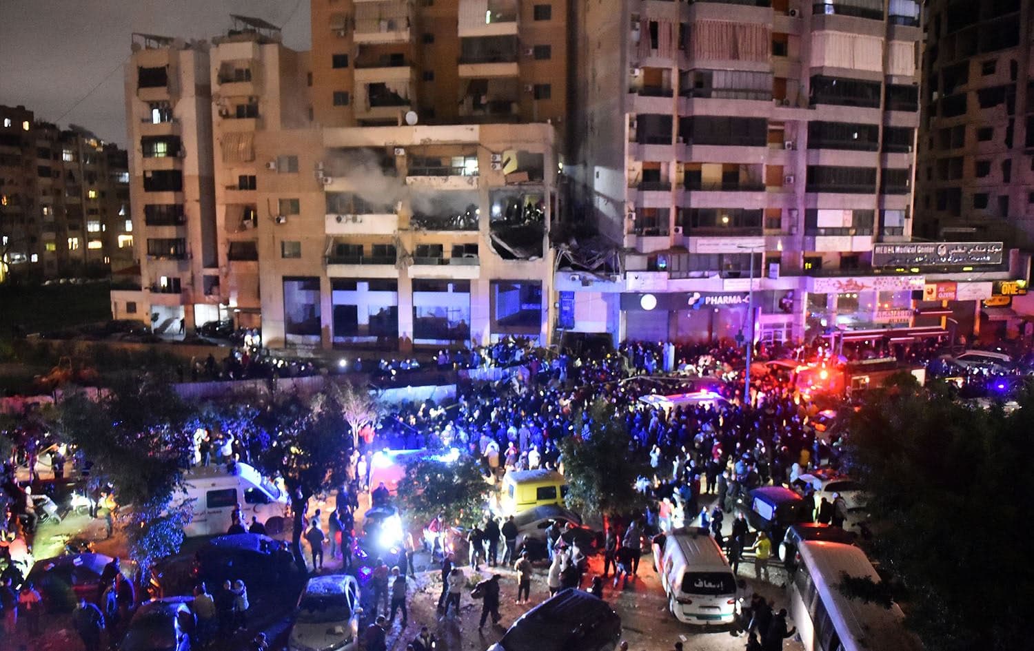 People gather at the site of a strike, reported by Lebanese media to be an Israeli strike targeting a Hamas office, in the southern suburb of Beirut on January 2, 2024. Photo: AFP