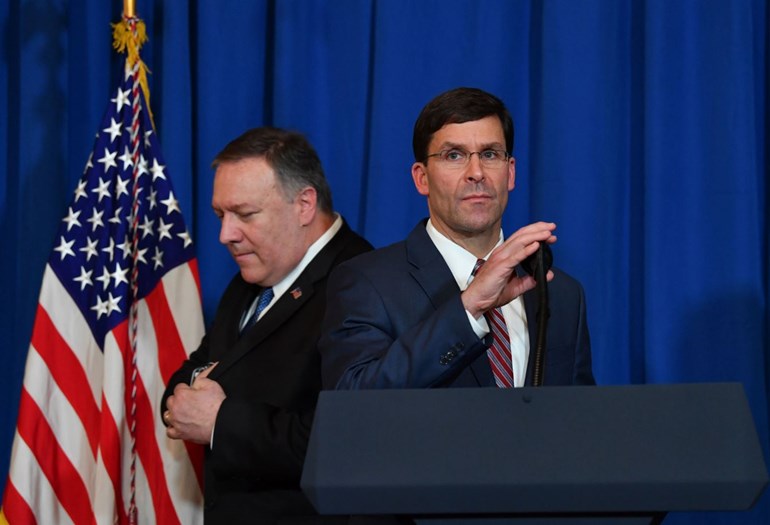 US Secretary of State Mike Pompeo (L) leaves the stage to US Secretary of Defense Mark Esper (R) during a briefing on the US strikes against Iraqi militia groups in Iraq and Syria. Photo: AFP / Nicholas Kamm